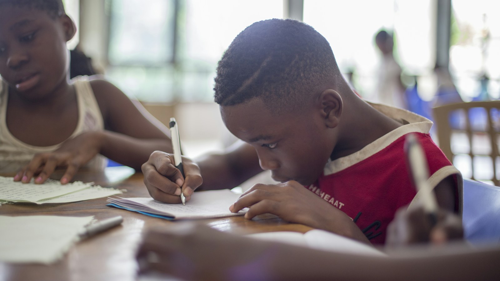 Children studying, representing family life and education insurance cover